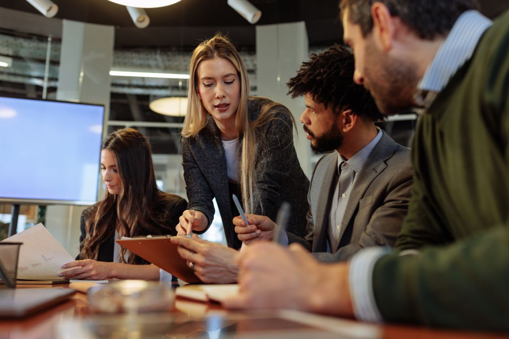 A group of colleagues collaborate to solve business problems
